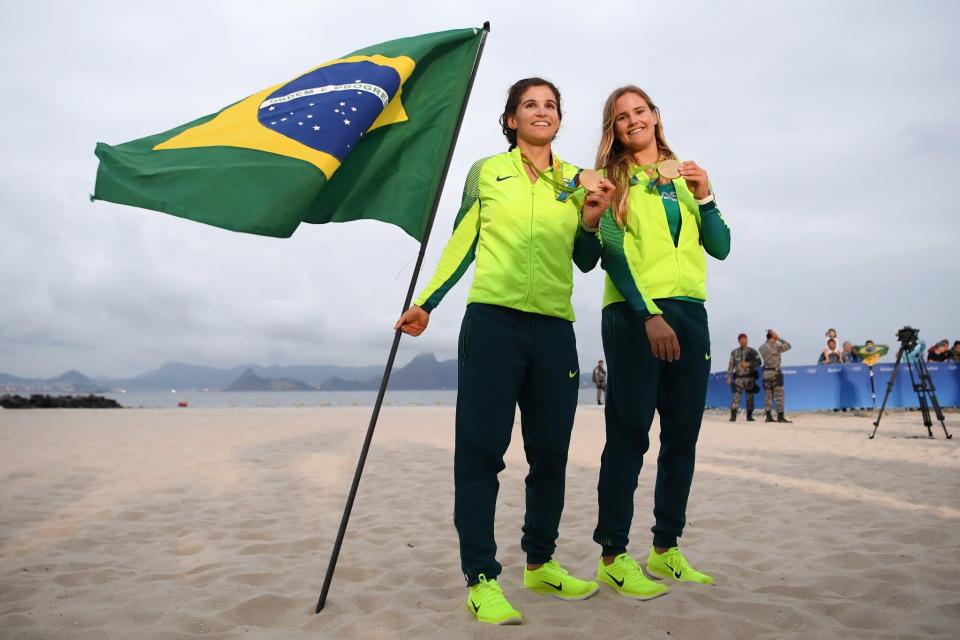 <p>(L-R) Martine Grael of Brazil and Kahena Kunze of Brazil celebrate winning gold in the Women’s 49er FX class at the Marina da Gloria on Day 13 of the 2016 Rio Olympic Games on August 18, 2016 in Rio de Janeiro, Brazil. (Photo by Matthias Hangst/Getty Images) </p>