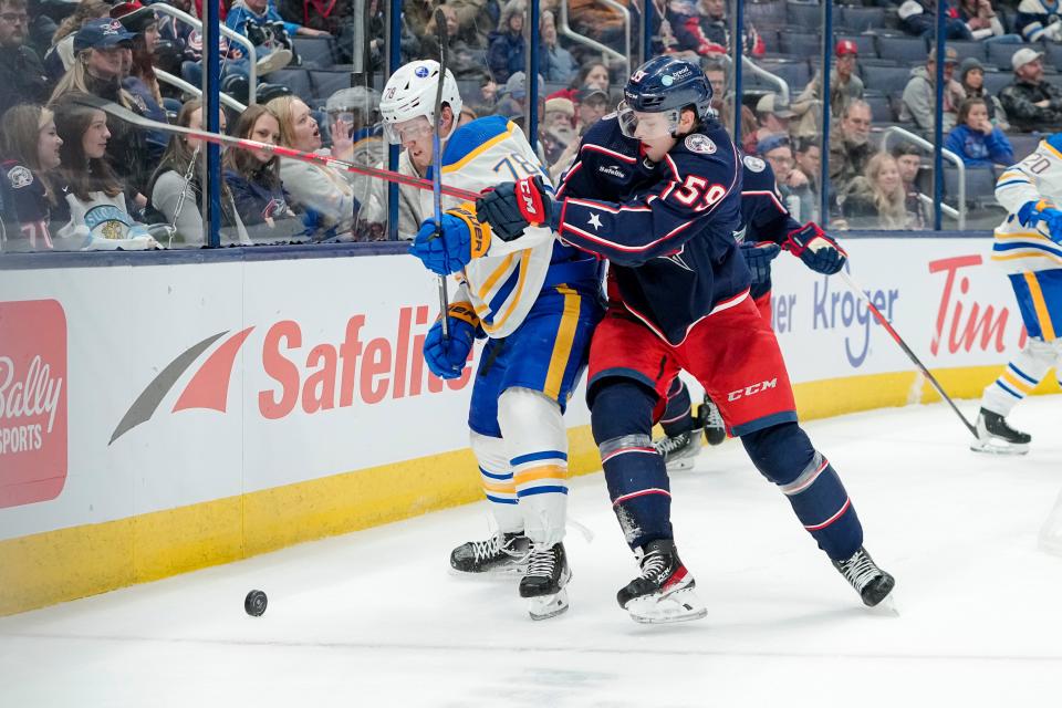 Dec 7, 2022; Columbus, Ohio, USA;  Columbus Blue Jackets right wing Yegor Chinakhov (59) hits Buffalo Sabres defenseman Jacob Bryson (78) during the third period of the NHL hockey game at Nationwide Arena. The Blue Jackets lost 9-4. Mandatory Credit: Adam Cairns-The Columbus Dispatch