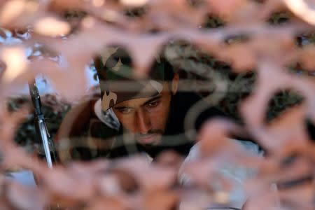 A rebel fighter sits at his position in Quneitra province, bordering the Israeli-occupied Golan Heights, Syria June 24, 2017. REUTERS/Alaa Al-Faqir