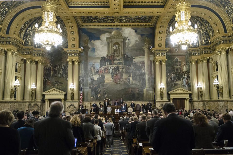 New Light Rabbi Jonathan Perlman prays with Pennsylvania lawmakers who came together in an unusual joint session to commemorate the victims of the Pittsburgh synagogue attack that killed 11 people last year, Wednesday, April 10, 2019, at the state Capitol in Harrisburg, Pa. (AP Photo/Matt Rourke)