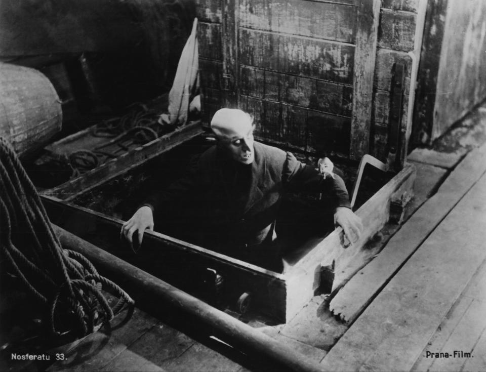 German actor Max Schreck (1879 - 1936), as the vampire Count Orlok, emerges (with a rat on his sleeve) onto the deck of the Demeter, in a scene from F. W. Murnau's expressionist horror film, 'Nosferatu, Eine Symphonie Des Grauens', 1921. The film is based on Bram Stoker's novel 'Dracula' and was released in 1922. (Photo by Frederic Lewis/Hulton Archive/Getty Images)