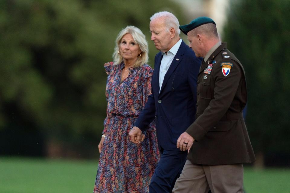 President Joe Biden and first lady Jill Biden, accompanied by Joint Base Myer-Henderson Hall Commander Col. David Bowling, right, arrive at Fort Lesley J. McNair in Washington after a weekend in Rehoboth Beach, Del., July 10, 2022.