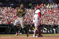 Pittsburgh Pirates' Oneil Cruz, left, scores past St. Louis Cardinals catcher Yadier Molina during the third inning of a baseball game Sunday, Oct. 2, 2022, in St. Louis. (AP Photo/Jeff Roberson)