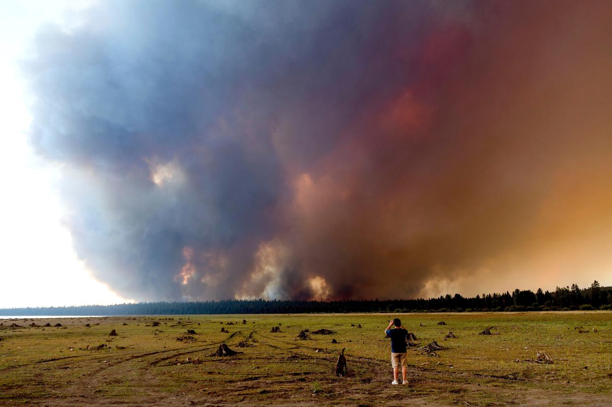 Geoff Foss watches as the Dixie Fire approaches Chester, Calif. on Tuesday, Aug. 3, 2021. Officials issued evacuation orders for the town earlier in the day as dry and windy conditions led to increased fire activity.