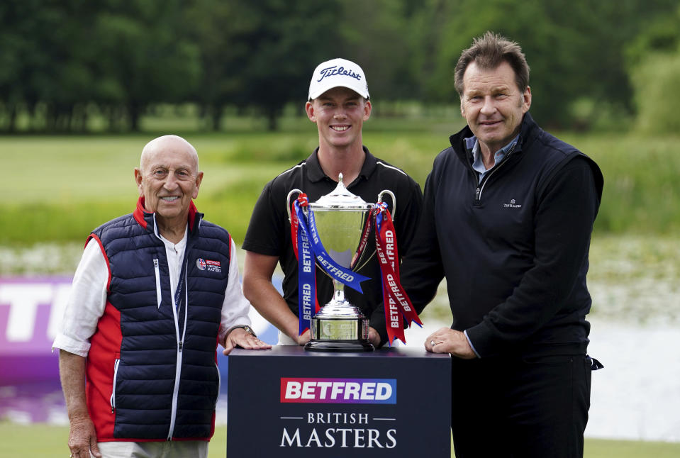 Daniel Hillier of New Zealand poses with the trophy, alongside Fred Done, left and Nick Faldo after day four of the Golf British Masters, at The Belfry, in Sutton Coldfield, England, Sunday July 2, 2023. (David Davies/PA via AP)