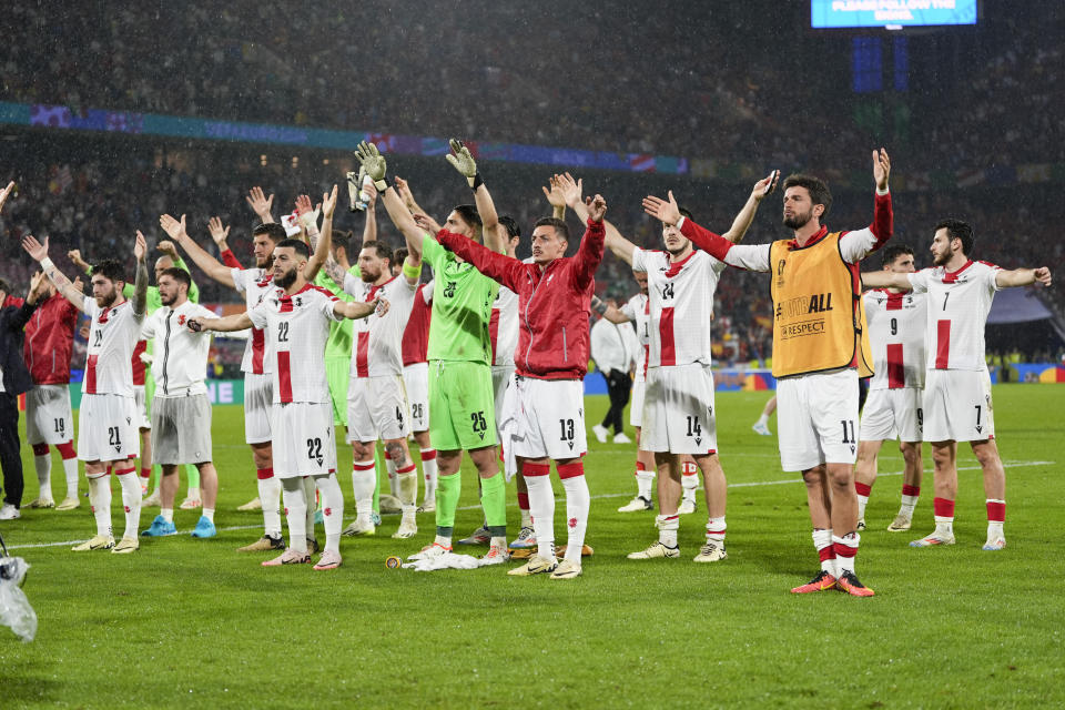 Georgia players acknowledge their fans after a round of sixteen match between Spain and Georgia at the Euro 2024 soccer tournament in Cologne, Germany, Sunday, June 30, 2024. (AP Photo/Martin Meissner)