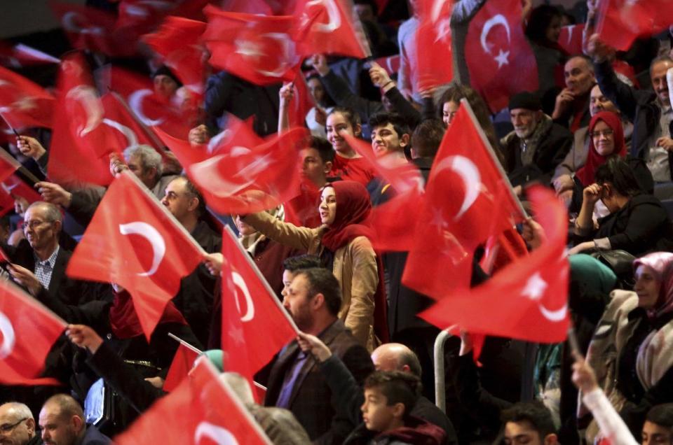 Supporters wait for a speech of Turkey's Prime Minister Binali Yildirim to promote a planned referendum in Turkey this year, in Oberhausen, Germany, Saturday Feb. 18, 2017. (Roland Weihrauch/dpa via AP)