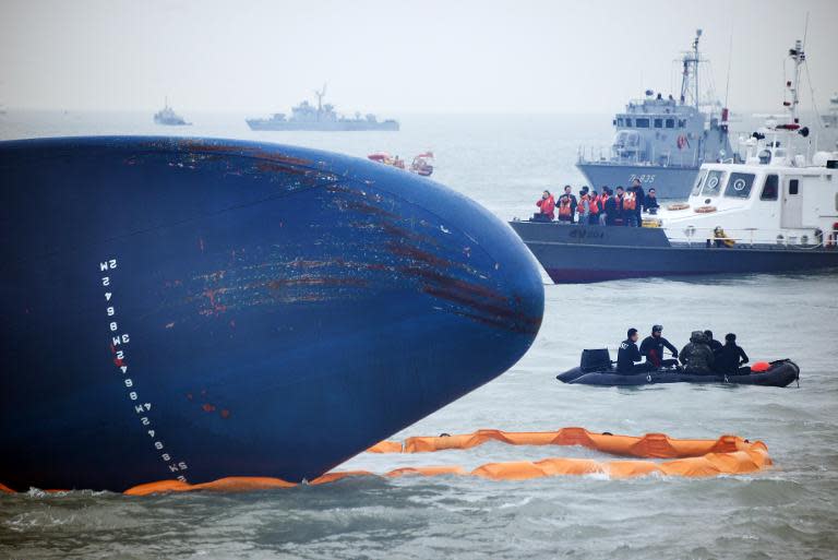 South Korean coastguards and divers search for missing passengers from a capsized ferry at sea some 20 kilometres off the island of Byungpoong in Jindo, on April 17, 2014