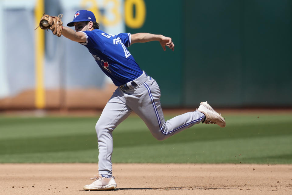 Toronto Blue Jays shortstop Ernie Clement reaches for a single hit by Oakland Athletics' Kevin Smith during the fourth inning of a baseball game in Oakland, Calif., Wednesday, Sept. 6, 2023. (AP Photo/Jeff Chiu)