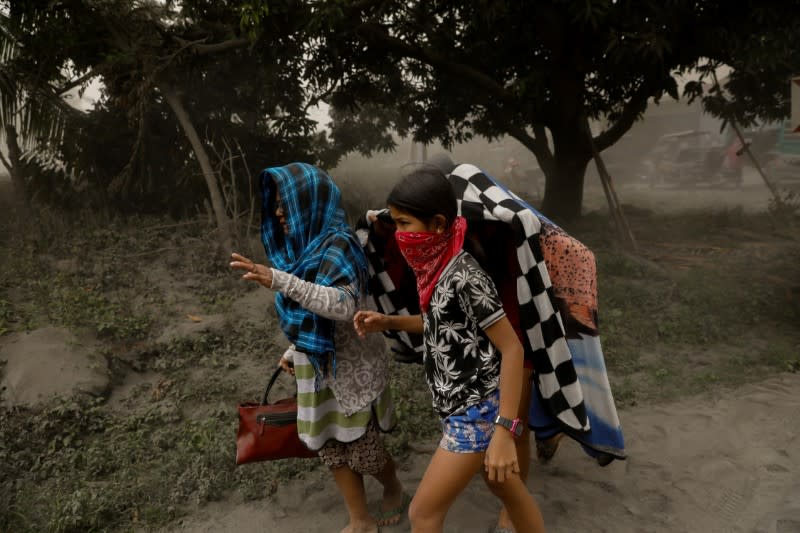 Residents living near the errupting Taal Volcano evacuate in Lemery, Batangas City