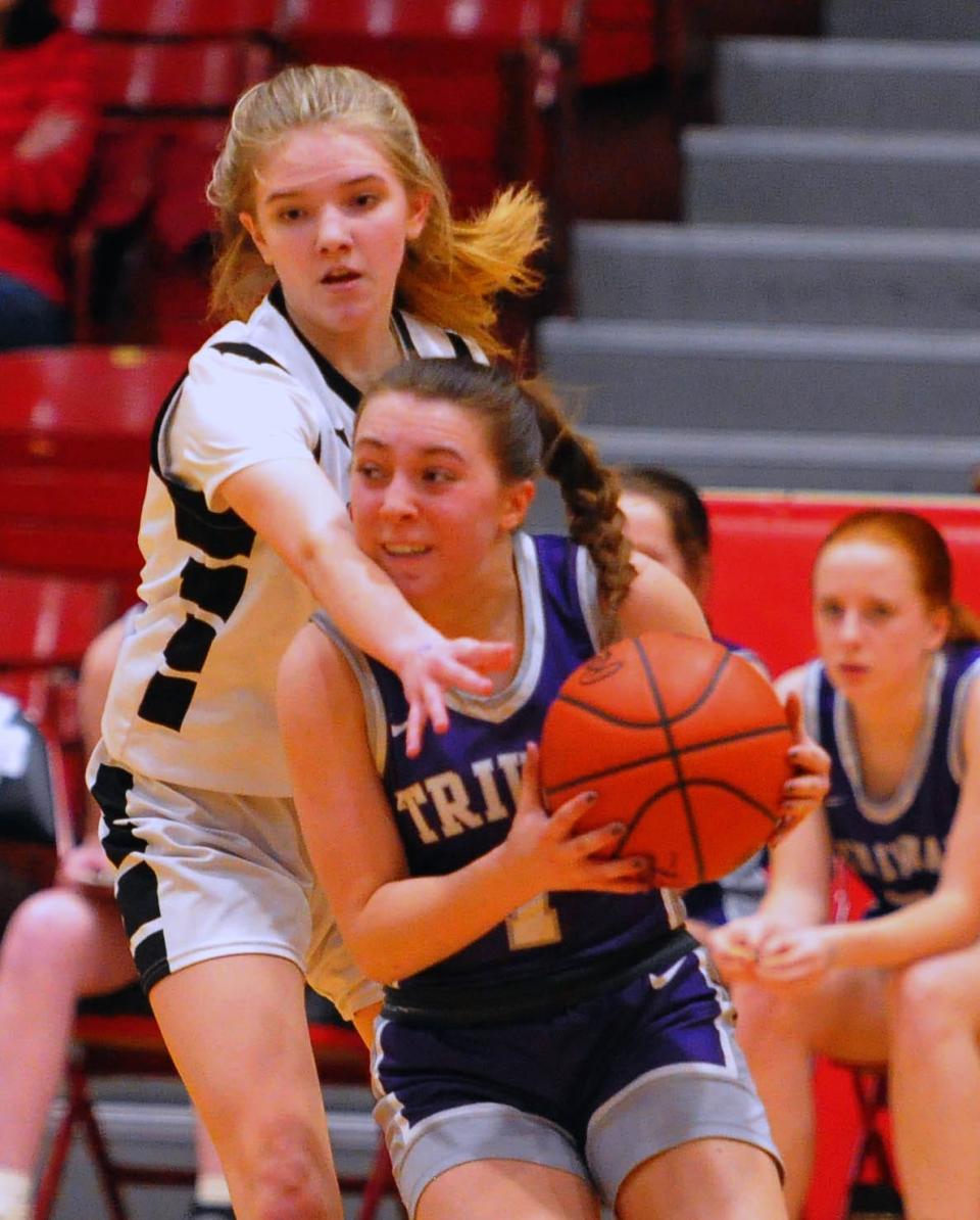 Triway's Payton Snyder is slowed down by Columbiana's Evy Rapp on the baseline.