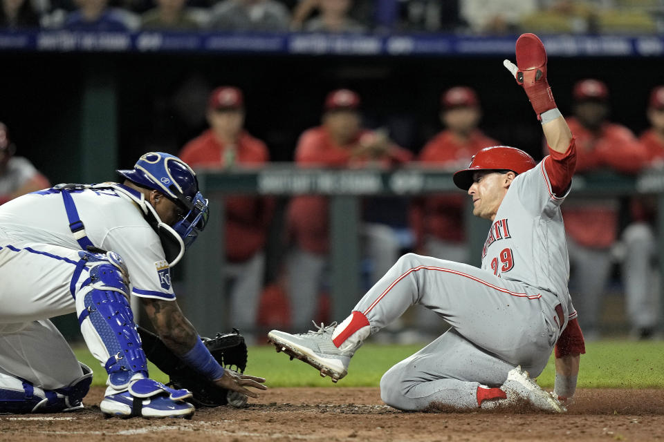 Cincinnati Reds' TJ Friedl (29) beats the tag by Kansas City Royals catcher Salvador Perez to score the winning run on a fielders choice hit into by Jonathan India during the tenth inning of a baseball game Monday, June 12, 2023, in Kansas City, Mo. The Reds won 5-4 in ten innings. (AP Photo/Charlie Riedel)