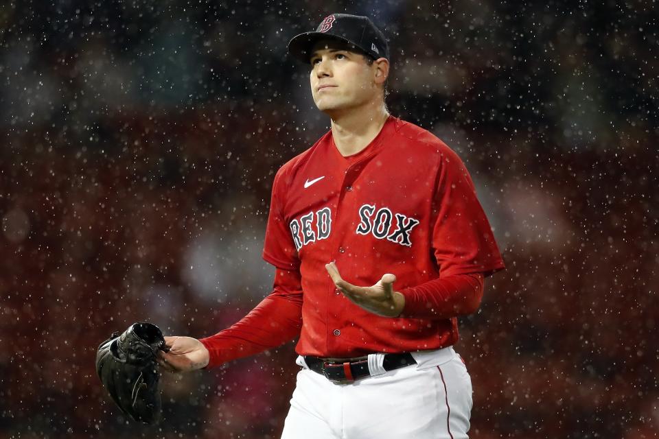 Boston Red Sox's Adam Ottavino reacts in the rain after striking out Miami Marlins' Isan Diaz with bases loaded to end the top of the sixth inning during a baseball game, Friday, May 28, 2021, in Boston. The game went into rain delay in the sixth inning and was called after an hour. (AP Photo/Michael Dwyer)