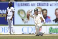 Australia's David Warner celebrates his team's ten wicket win over Sri Lanka after scoring the winning run in day three of the first test cricket match between Australia and Sri Lanka in Galle, Sri Lanka, Friday, July 1, 2022. (AP Photo/STR)