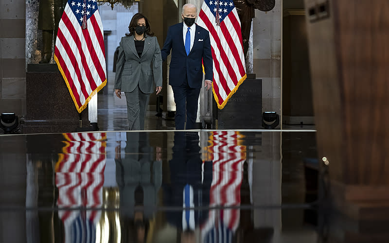 Vice President Harris and President Biden arrive to give remarks in Statuary Hall on Jan. 6 to mark the first anniversary of the attack on the Capitol. <em>Greg Nash</em>