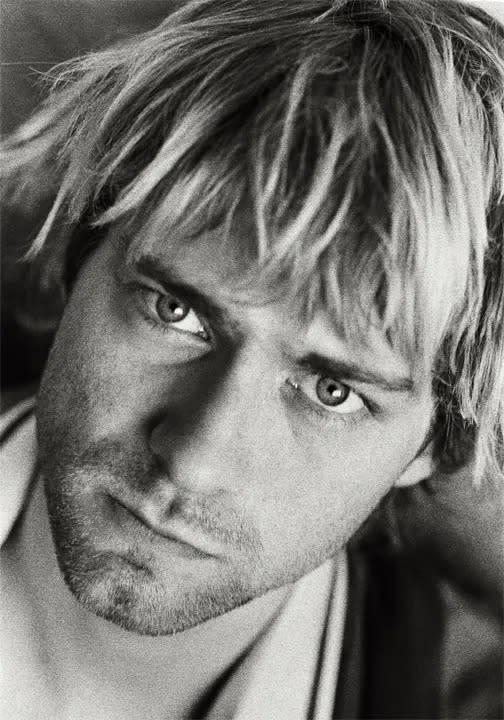 A black and white close up photo of Kurt Cobain