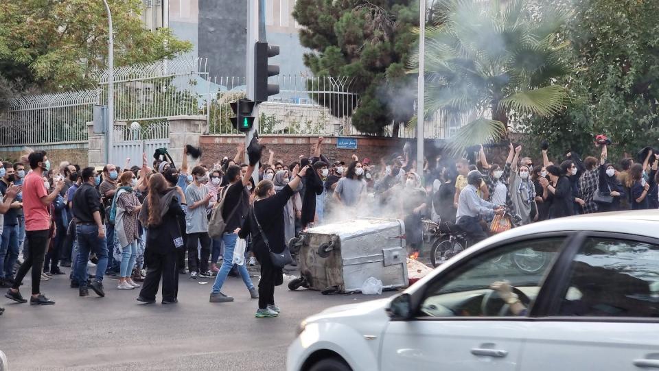 People demonstrate in Tehran in September 2022 to protest the death of 22-year-old Mahsa Jhina Amini, a woman who was arrested and killed for improperly covering her hair in Tehran. <a href="https://www.gettyimages.com/detail/news-photo/people-gather-in-protest-against-the-death-of-mahsa-amini-news-photo/1426271236?adppopup=true" rel="nofollow noopener" target="_blank" data-ylk="slk:Getty Images;elm:context_link;itc:0;sec:content-canvas" class="link ">Getty Images</a>