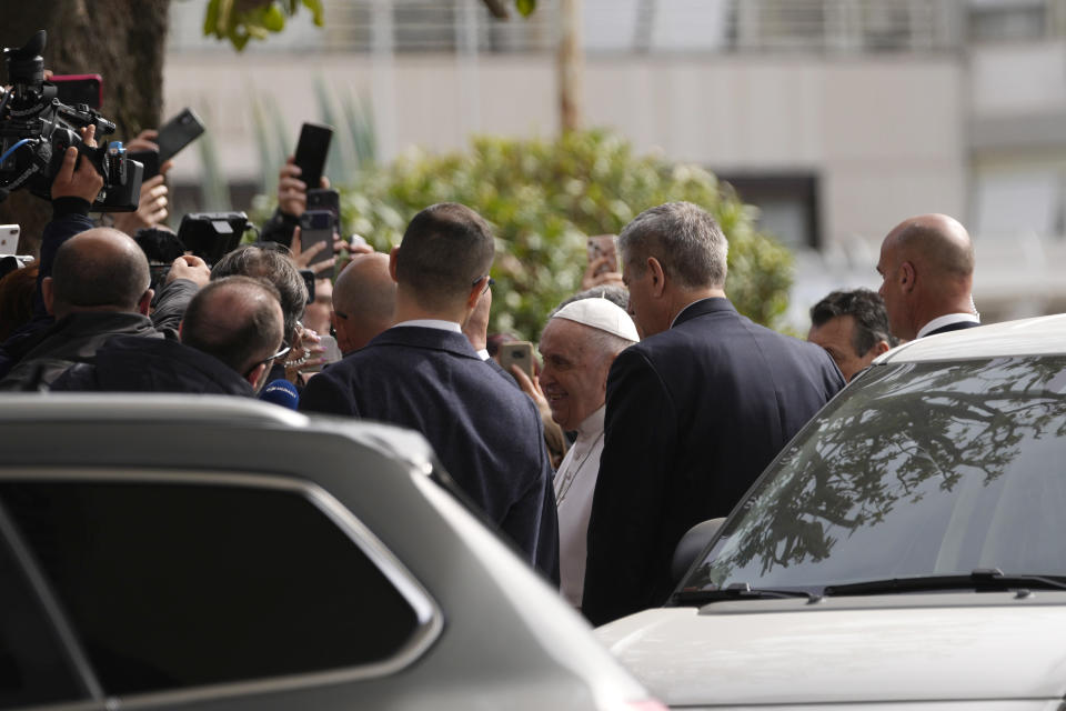 Pope Francis talks with journalists as he leaves the Agostino Gemelli University Hospital in Rome, Saturday, April 1, 2023 after receiving treatment for a bronchitis, The Vatican said. Francis was hospitalized on Wednesday after his public general audience in St. Peter's Square at The Vatican. (AP Photo/Domenico Stinellis)