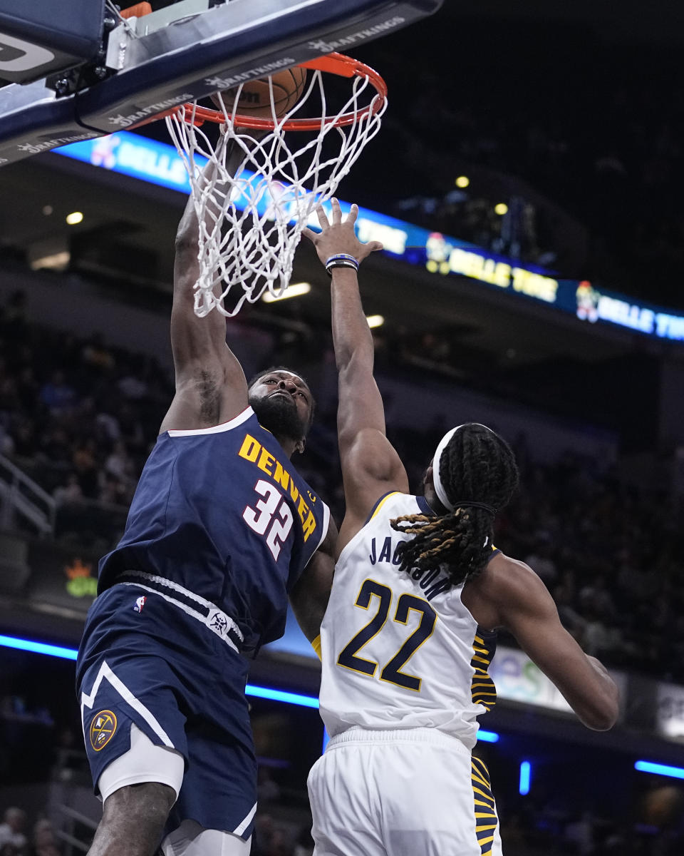 Denver Nuggets' Jeff Green (32) dunks against Indiana Pacers' Isaiah Jackson (22) during the first half of an NBA basketball game, Wednesday, Nov. 9, 2022, in Indianapolis. (AP Photo/Darron Cummings)