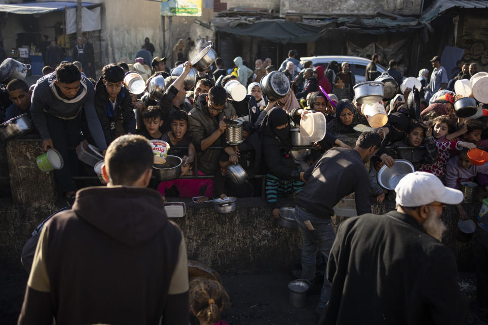 Palestinians line up for a free meal in Rafah, Gaza Strip, on Tuesday, March 12, 2024. (AP Photo/Fatima Shbair)