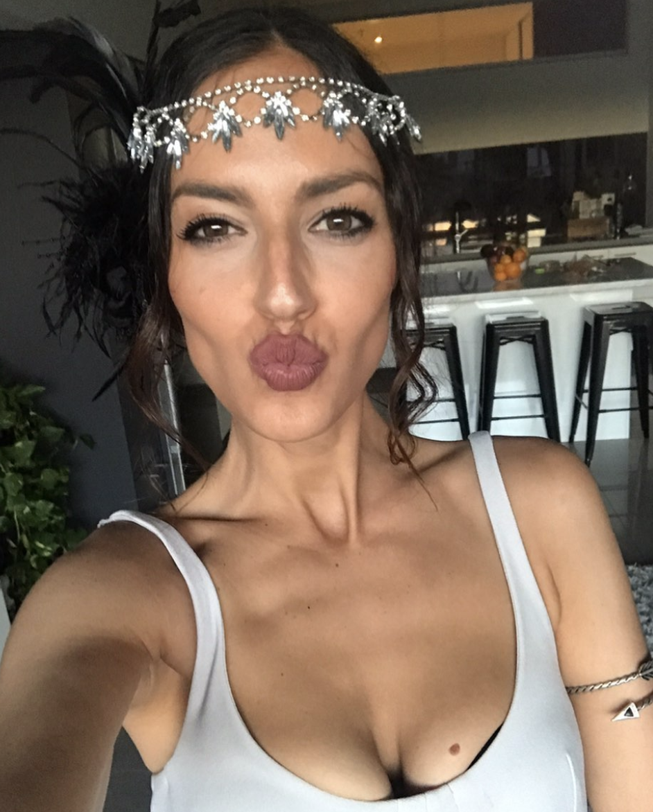 Natalie Kyriacou wearing a white singlet top and a silver beaded headband