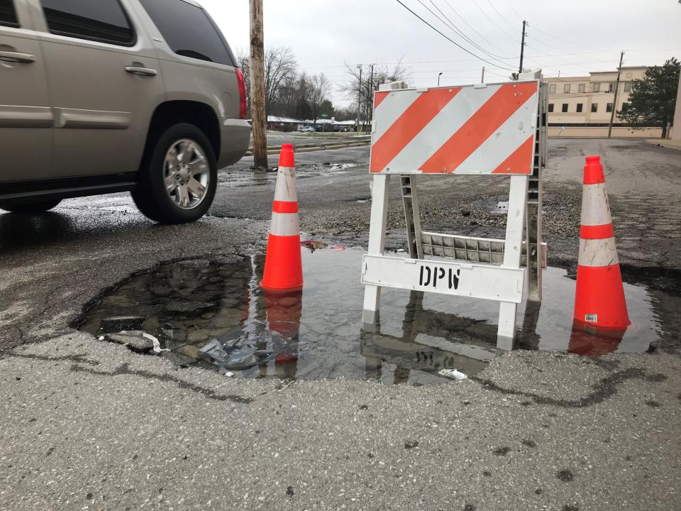 A pothole is blocked from traffic on a sideroad near U.S. 31 on Indianapolis' south side on Sunday, March 15, 2020.