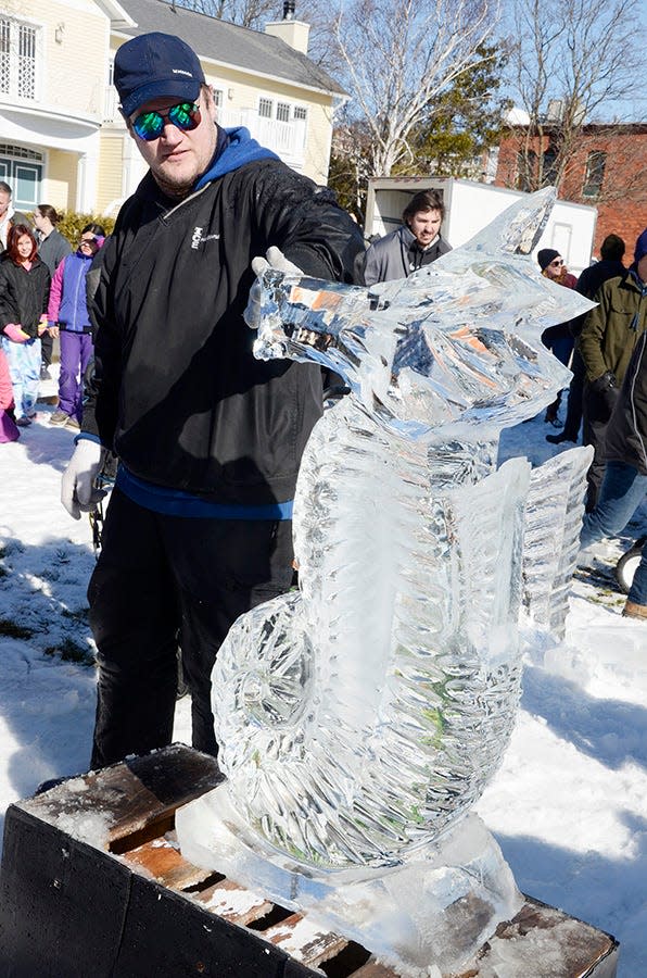 Matthew Larsen of Ice Creations shows off his winning seahorse sculpture following the dueling chainsaws contest on Saturday, Feb. 11, 2023 during the Harbor Springs Ice Fest.
