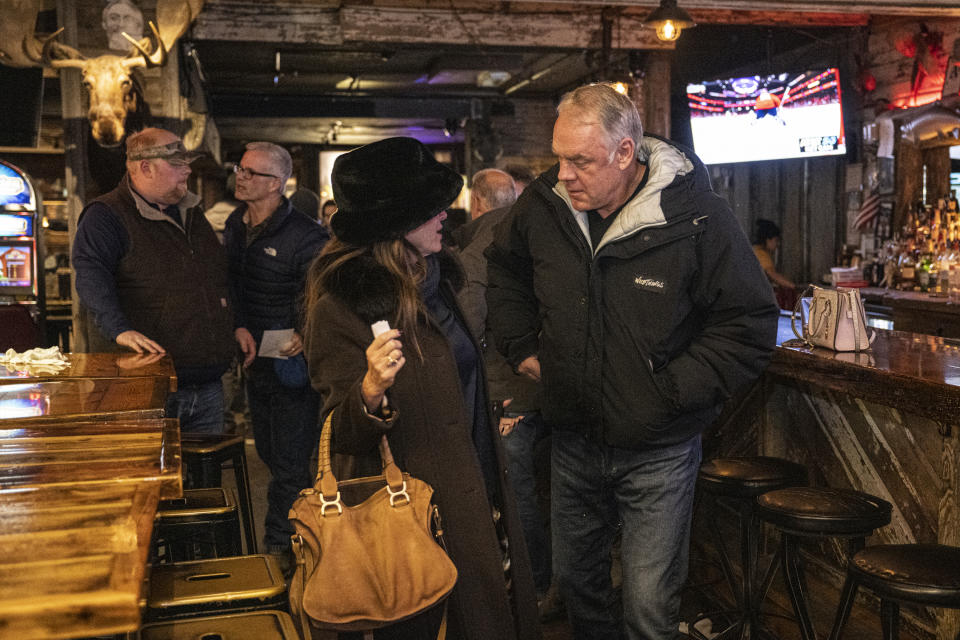 Former Interior Secretary and Republican House candidate Ryan Zinke and his wife Lola leave The Remington Bar after eating dinner together in Whitefish, Mont., on Wednesday, Nov. 9, 2022. (AP Photo/Tommy Martino)