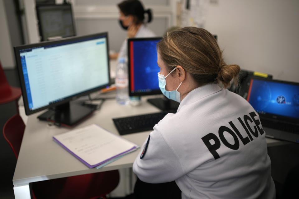 French female police officers work in a police station in Paris, Tuesday, Nov. 23, 2021. France's government says it must do more to help women report sexual and other violence to the police, and unveils a new process to file a complaint at a friend's home or in a shelter where women feel safer. (AP Photo/Christophe Ena)