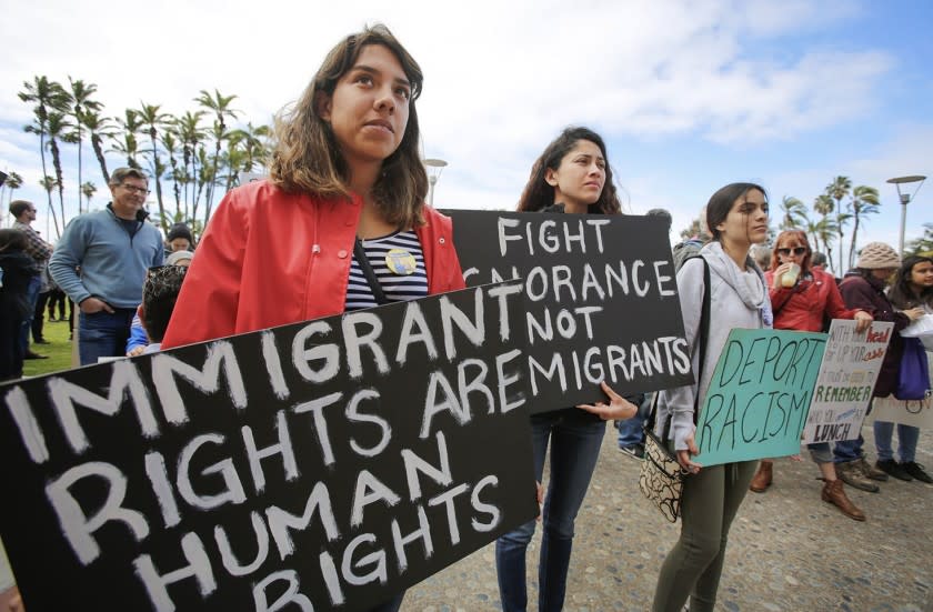 Top left: Francisca Verduzco, left, and her sister, Itzel Verduzco, center, hold signs supporting immigrant rights while attending March in Solidarity with Immigrants, San Diego. Top right: Kyle Fox, 4, and his father, Brady Fox, hold a sign at a vigil held to support the victims of the Chabad of Poway synagogue shooting. Bottom right: Emily Jones, right, and her daughters Tyra Neptune-Lucas, 12, second from right, and Lyssa Ballard, 16, center, hold signs on Espola Road to show support for Chabad of Poway. Bottom left: Kamri Jackson, center, holds up a sign as she and other people protest the Supreme Court's decision to uphold Donald Trump's travel ban while in front of the Edward J. Schwartz Federal Building in San Diego.