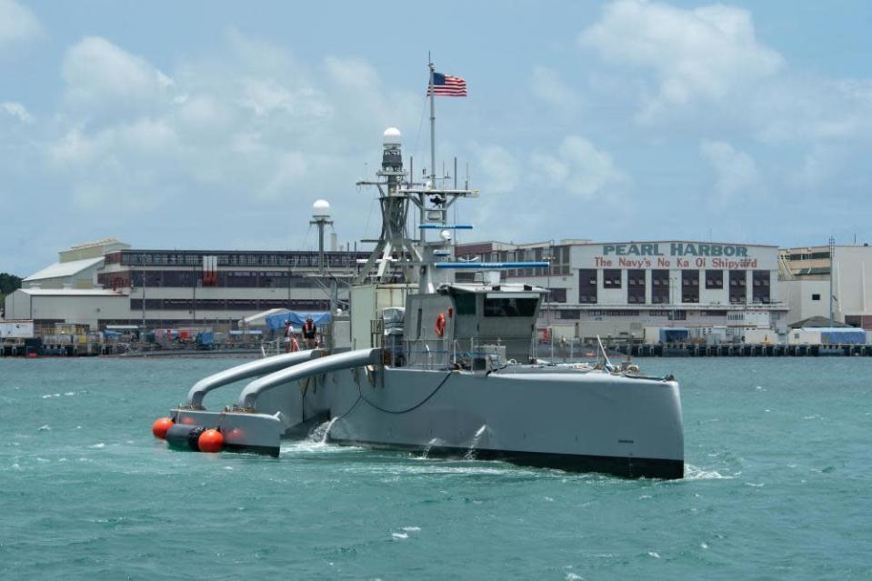 In this image provided by the U.S. Navy, a Sea Hunter, a crewless vessel, arrives at Pearl Harbor, Hawaii, to participate in the Rim of Pacific (RIMPAC) 2022, on June 29, 2022. The Navy is expediting development of drone ships aimed at expanding the reach of offensive firepower while keeping sailors on traditional warships farther from harm's way. (U.S. Navy photo by Mass Communication Specialist 2nd Class Aiko Bongolan, via AP)