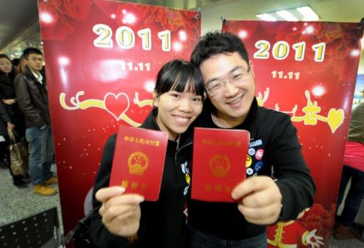 A Chinese couple show their marriage certificates at a marriage registration office in Hefei, east China's Anhui province, on November 11. Chinese couples flocked to registry offices to marry on in the belief that the "11.11.11" date is the most auspicious in a century