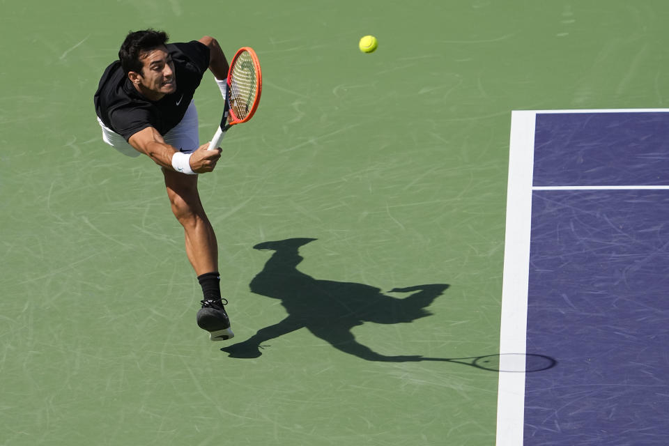 Cristian Garin, of Chile, returns a shot to Casper Ruud, of Norway, at the BNP Paribas Open tennis tournament Sunday, March 12, 2023, in Indian Wells, Calif. (AP Photo/Mark J. Terrill)