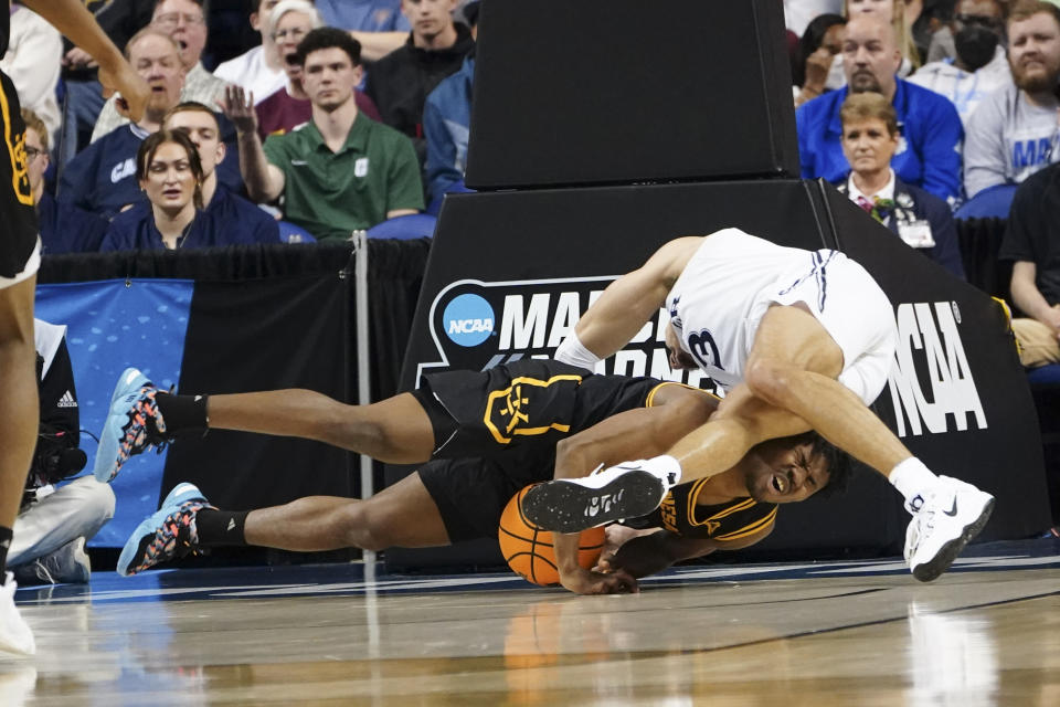 Kennesaw guard Terrell Burden (1) and Xavier guard Colby Jones (3) battle for the ball during the first half of a first-round college basketball game in the NCAA Tournament on Friday, March 17, 2023, in Greensboro, N.C. (AP Photo/John Bazemore)