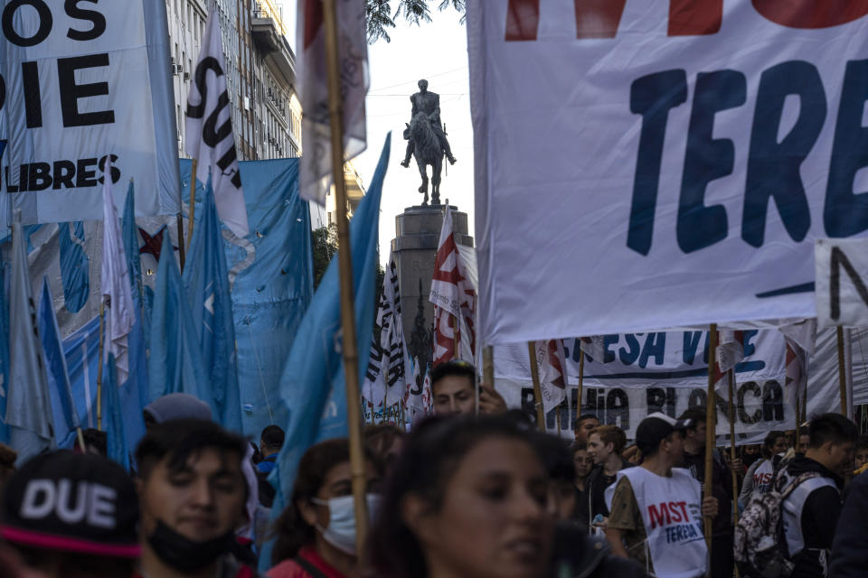 Demonstrators walk past a monument of former President Julio Roca during a march to the Plaza de Mayo organized by social organizations demanding more jobs and higher wages, in Buenos Aires, Argentina, Thursday, May 12, 2022. Such organizations have long been present in Argentina but they grew and became more powerful at the end of 2001, when the country suffered the worst economic collapse in its history that plunged half the population into poverty. (AP Photo/Rodrigo Abd)