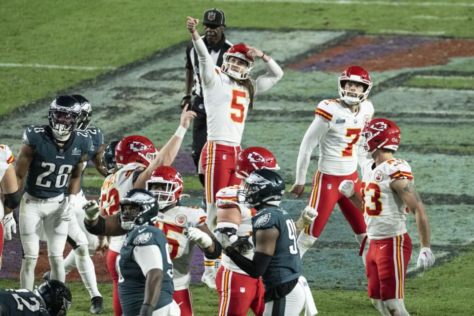 Kansas City Chiefs kicker Harrison Butker celebrates after kicking a game-winning field goal.