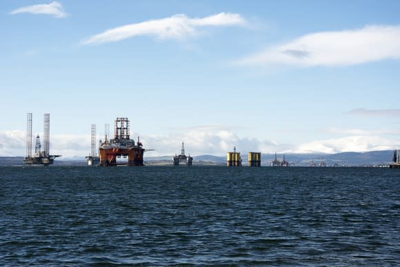 A line of idled offshore drilling rigs.