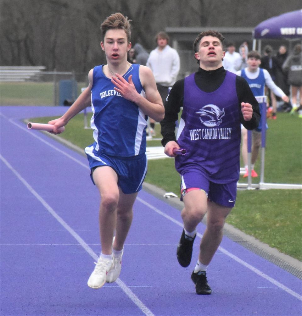 Dolgeville Blue Devil Francis Roche and West Canada Valley Nighthawk John Tubia (from left) race to the finish line running the anchor leg of the four-by-400-meter relay Thursday in Newport.