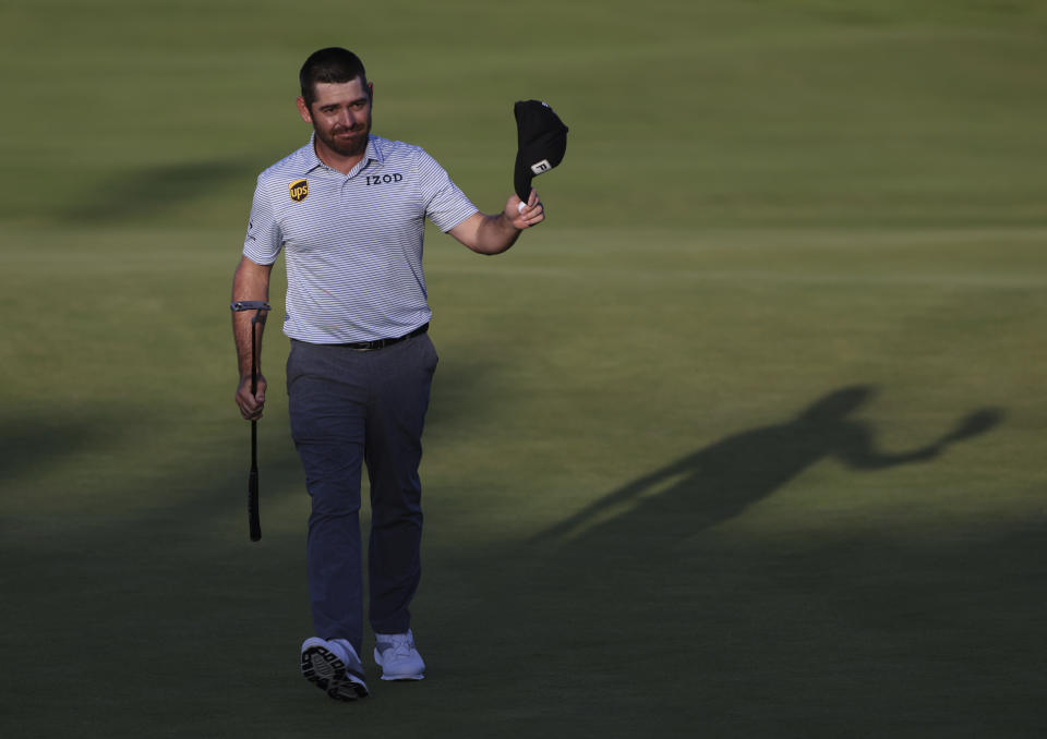 South Africa's Louis Oosthuizen acknowledges the crowd as he walks from the 18th green after completing his third round at the British Open Golf Championship at Royal St George's golf course Sandwich, England, Saturday, July 17, 2021. (AP Photo/Ian Walton)