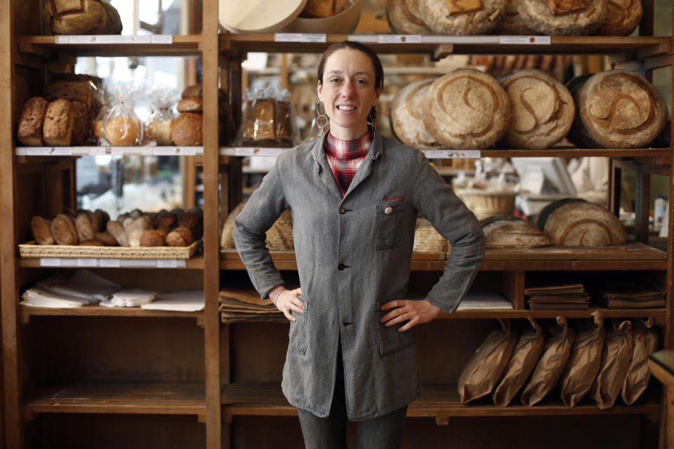 This Oct. 9, 2019 photo shows third generation baker Apollonia Poilane posing in the Poilane bakery, in Paris. She has authored her first English-language cookbook, “Poilane: The Secrets of the World-Famous Bread Bakery," with a weighty collection of nearly 100 recipes. (AP Photo/Thibault Camus)