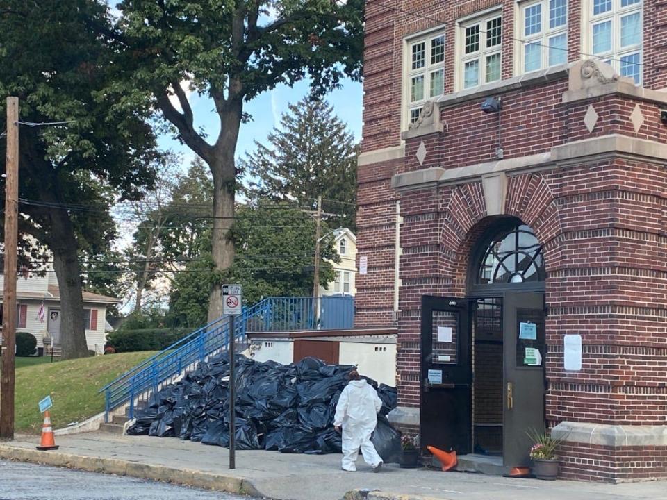 A worker removed debris from the Lincoln School in Nutley, which was damaged by a fire on Monday, Oct. 9, 2023.