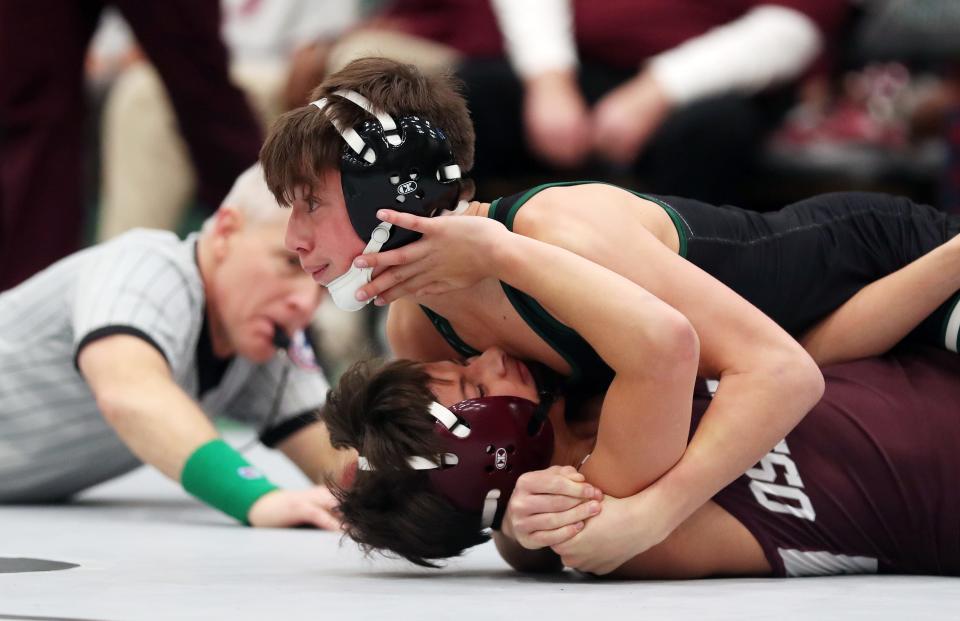 Cooper Constantine from Yorktown and Nick Lofaro from Ossining wrestle in the 101-pound weight class during the Section 1 Division I Dual Meet Tournament at Yorktown High School Dec. 21, 2023. Constantine won the match.