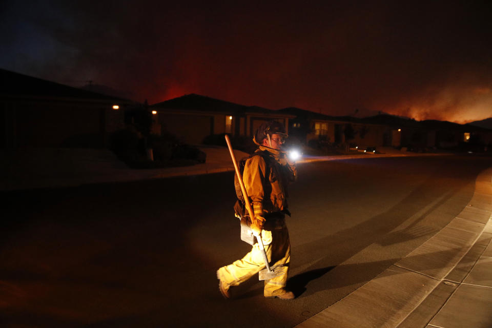 <p>A firefighter looks for flammable items in an evacuated residential area as wildfires continue to burn Saturday, Oct. 14, 2017, in Santa Rosa, Calif. (Photo: Jae C. Hong/AP) </p>