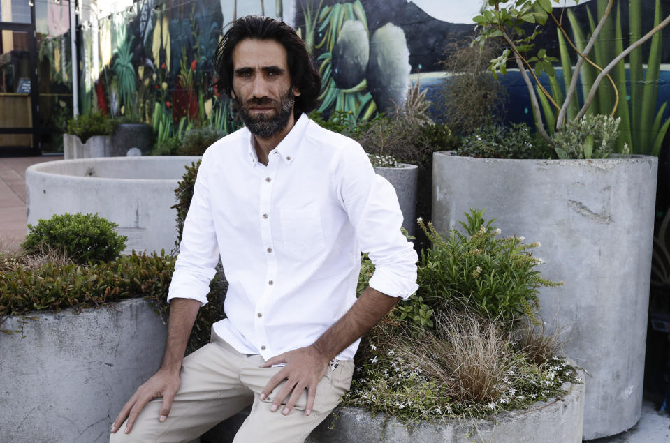 In this Nov. 19, 2019, photo, Behrouz Boochani, the Kurdish film-maker, writer and refugee who has documented life inside the Australian offshore immigration camp on Manus Island, poses for a portrait in Christchurch, New Zealand. (AP Photo/Mark Baker)