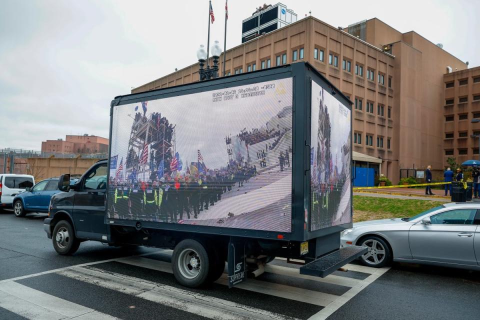 Footage of the January 6 riot is screened on the side of a truck outside the jail (Getty Images for Congressional I)