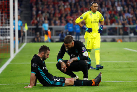 Soccer Football - Champions League Semi Final First Leg - Bayern Munich vs Real Madrid - Allianz Arena, Munich, Germany - April 25, 2018 Real Madrid's Dani Carvajal lies injured with Sergio Ramos REUTERS/Kai Pfaffenbach