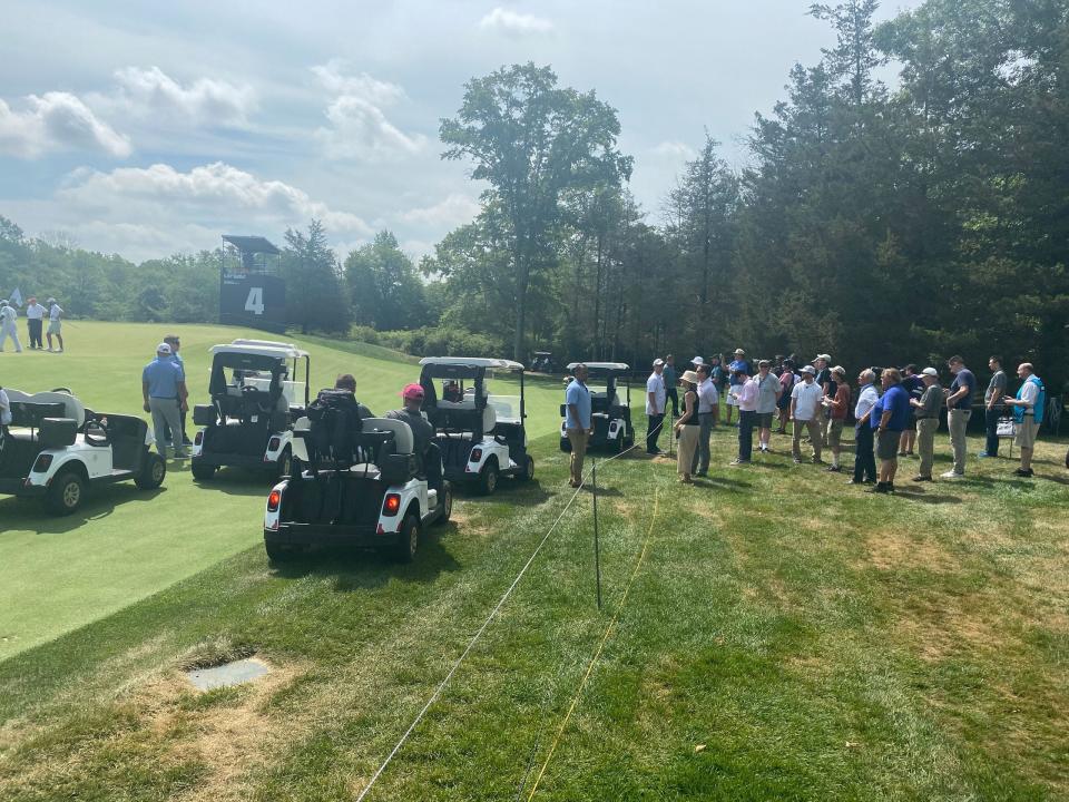 A group of golf carts wait to follow former President Trump.