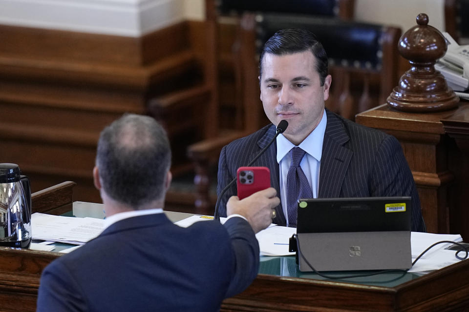 Whistleblower witness Ryan Vassar, former deputy attorney general, right, is shown an image by defense attorney Mitch Little as he testifies during day four of the impeachment trial for Texas Attorney General Ken Paxton in the Senate Chamber at the Texas Capitol, Friday, Sept. 8, 2023, in Austin, Texas. (AP Photo/Eric Gay)