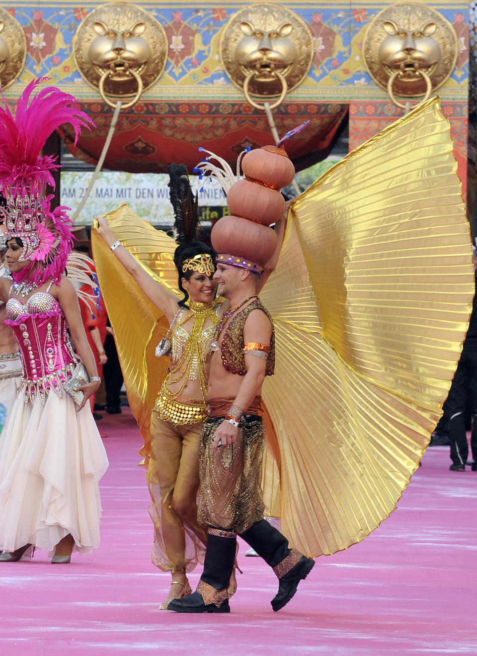 Guests in fancy costumes arrive for the opening ceremony of the 21st Life Ball in front of city hall in Vienna, Austria, on Saturday, May 25, 2013. The Life Ball is a charity gala to raise money for people living with HIV and AIDS. (AP Photo/Hans Punz)