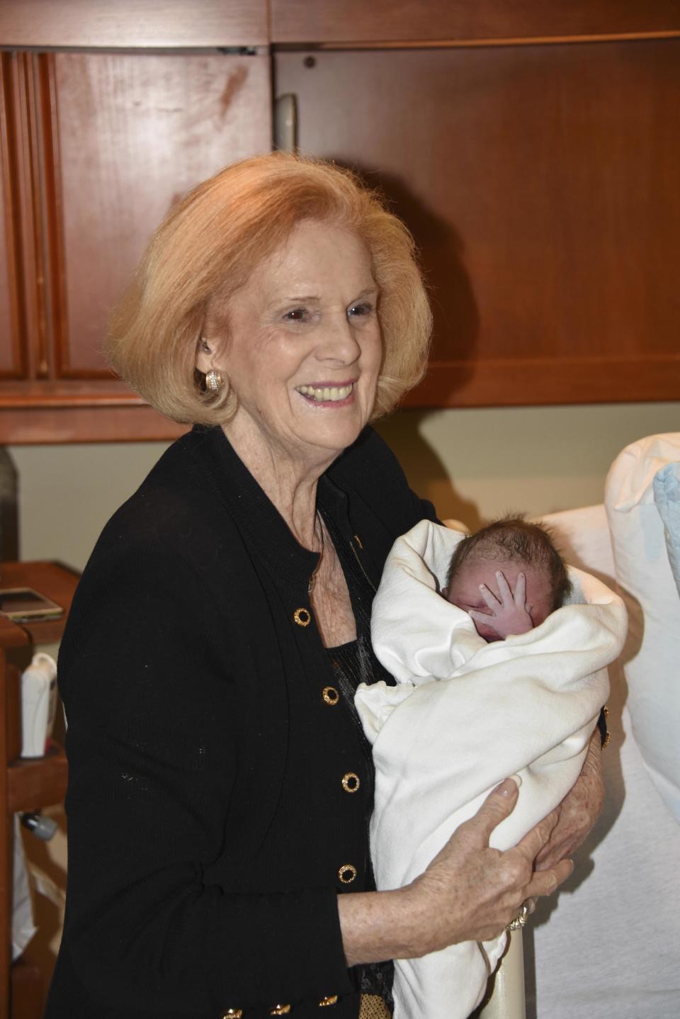 In this 2014 photo provided by a former member of the church, Word of Faith Fellowship leader Jane Whaley holds the newborn baby of a congregant of her church in Spindale, N.C. Word of Faith Fellowship has been scrutinized on numerous occasions by law enforcement, social services agencies and the news media since the early 1990s_ all without significant impact, mostly because followers refused to cooperate. (AP Photo)